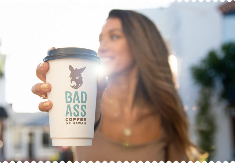 Woman holding a Bad Ass Coffee cup