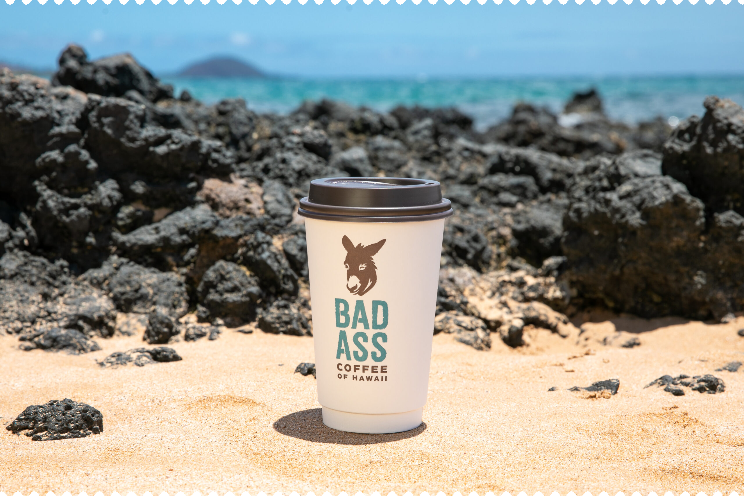 Coffee cup on a volcanic beach