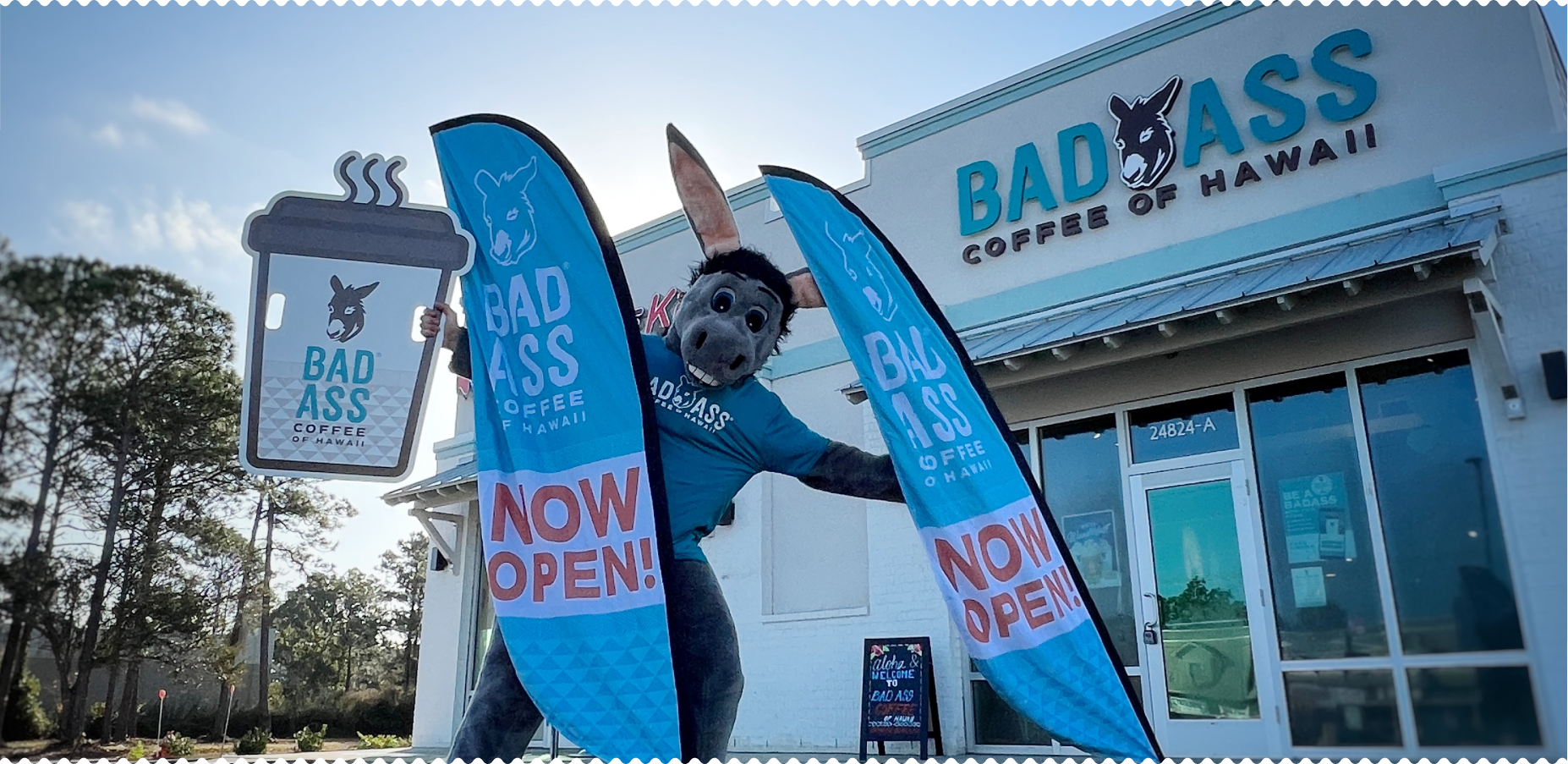 A Bad Ass Coffee of Hawaii grand opening with mascot and flags